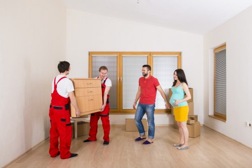 Professional movers handling furniture for a small removals job