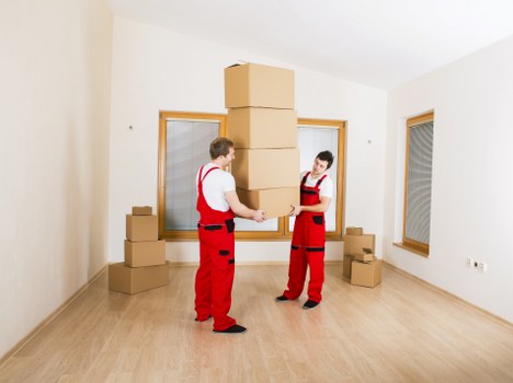 Professional movers packing household items for a local move